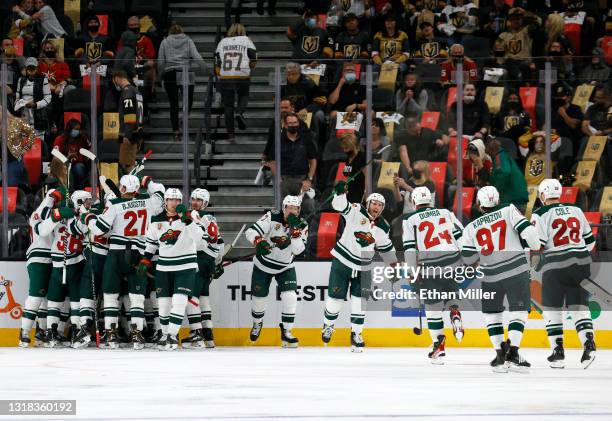 The Minnesota Wild celebrate after Joel Eriksson Ek scored an overtime goal against the Vegas Golden Knights to win Game One of the First Round of...
