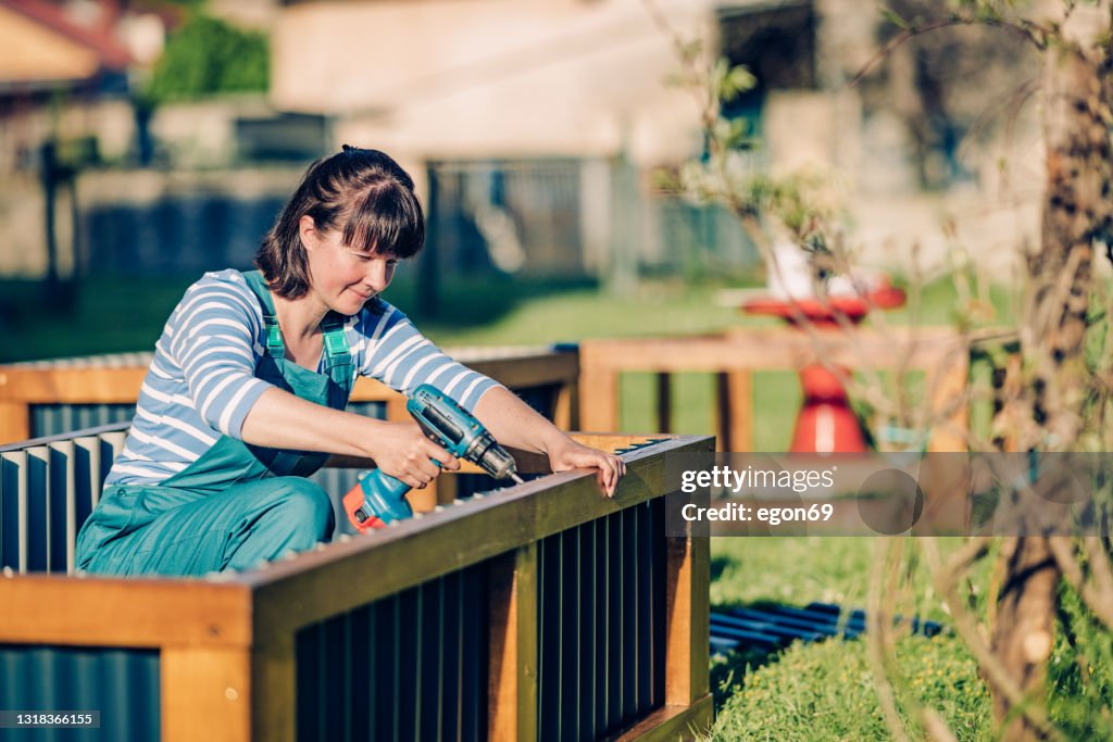 Woman building raised bed