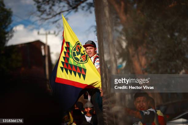 Fan of America poses with a flag of his team before the quarterfinals second leg match between America and Pachuca as part of the Torneo Guard1anes...