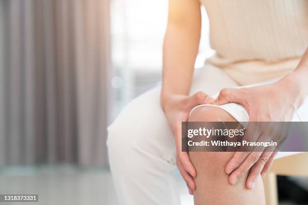 woman having knee pain in medical - female knee pain stock-fotos und bilder