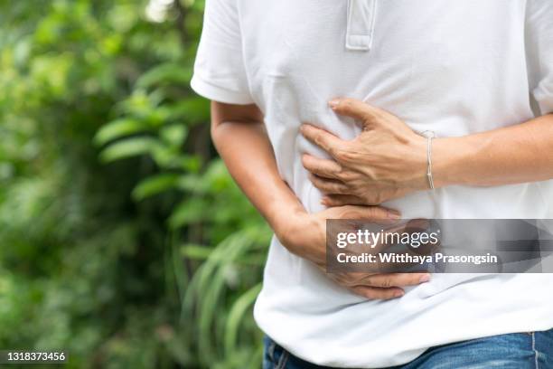 young man having a stomachache concept man having a heart attack."n - acid reflux stock pictures, royalty-free photos & images