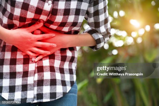 young woman having stomach pain - food borne illness stock pictures, royalty-free photos & images