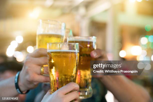 a group of friends with drinks at a nightclub. young people are enjoying - beer taps bildbanksfoton och bilder