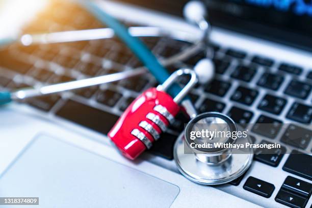 computer or data analysis - stethoscope over a laptop computer keyboard toned in blue - ransomware stock pictures, royalty-free photos & images