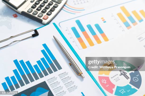 charts. business reports and pile of documents on gray reflection background - financial planner stockfoto's en -beelden