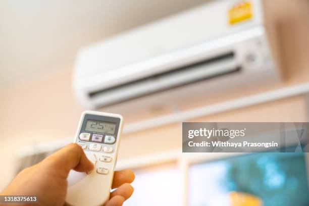 switching on air conditioner - airco stockfoto's en -beelden