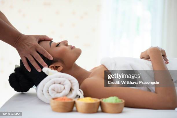 young woman enjoying massage in spa salon - thai massage 個照片及圖片檔