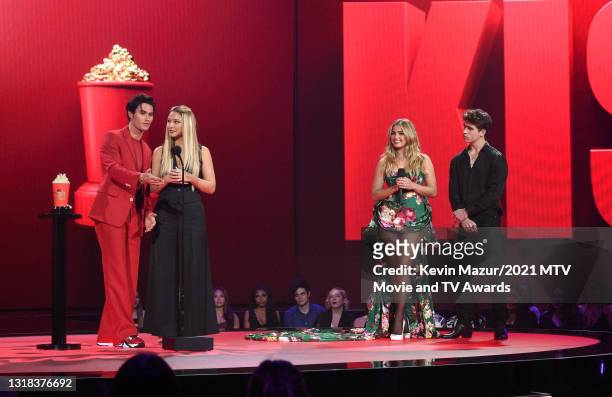 Chase Stokes and Madelyn Cline accept the Best Kiss award for 'Outer Banks' from Addison Rae and Tanner Buchanan onstage during the 2021 MTV Movie &...