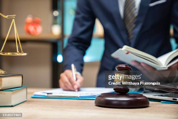 close up lawyer businessman working or reading lawbook in office workplace for consultant lawyer concept - lagstiftning bildbanksfoton och bilder