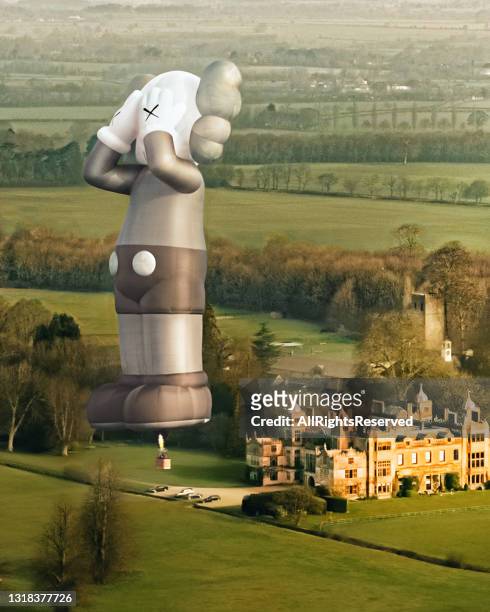 In this photo released on May 17 artist KAW’s latest work and the 42-meter tall hot-air balloon ‘KAWS:HOLIDAY’ takes flight prior to May 16, 2021 in...