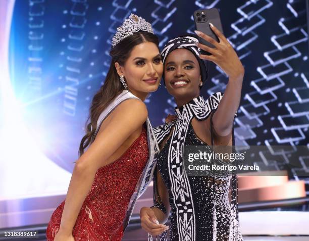 Miss Universe 2020 Andrea Meza and Miss Universe 2019 Zozibini Tunzi take a selfie onstage at the 69th Miss Universe competition at Seminole Hard...