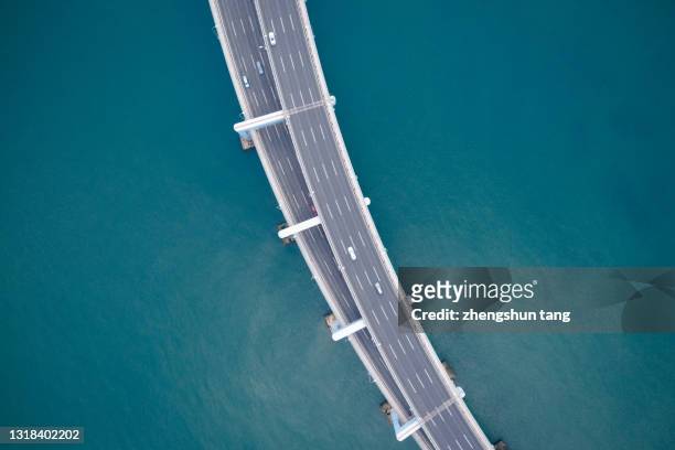 drone view curve road of xing hai bay bridge, dalian - drone city building day ストックフォトと画像