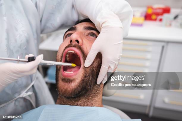dentist injecting anesthesia to patient - streptococcus stock pictures, royalty-free photos & images