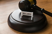 Bylaws phrase with gavel on wooden background. Business and law concept