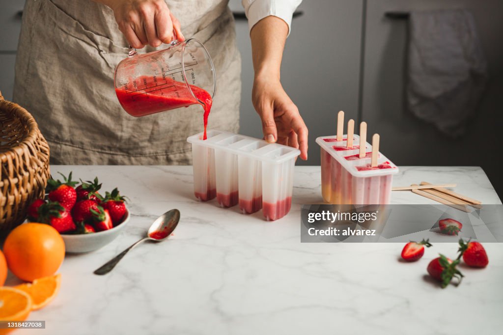 Filling liquid ice cream mix in moulds