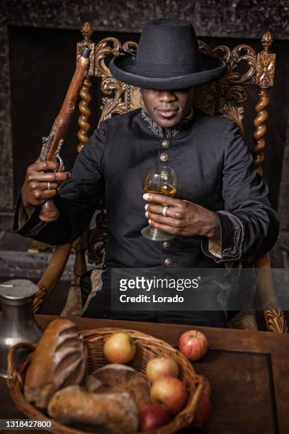 african traditionally dressed european man with a weapon - bounty hunter stock pictures, royalty-free photos & images
