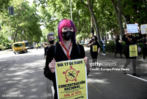 Person of the aesthetics sector comes with a banner to a demonstration organized from the Paseo del Prado to the Congress of Deputies, on 17 May,...