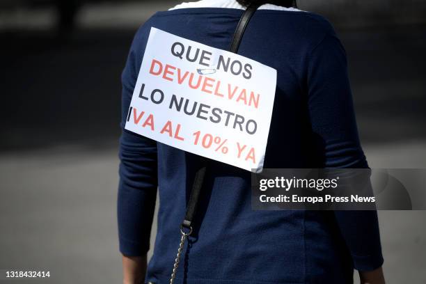 Person of the aesthetics sector comes with a poster where you can read "Give us back ours, VAT at 10% now" in a demonstration organized from the...