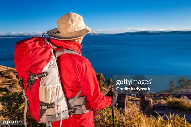 joven turista admirando una vista en la isla taquile, lago titicaca, perú - lago titicaca fotografías e imágenes de stock