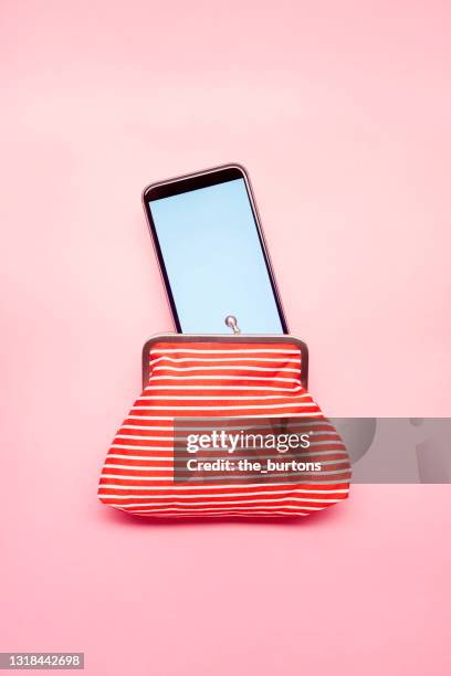 still life of a red wallet and smartphone on pink background - phone still life stock pictures, royalty-free photos & images