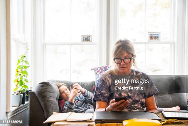 working from home.  a mother and son. - working from home stress stock pictures, royalty-free photos & images