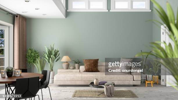 modernes wohnzimmer-interieur mit grünen pflanzen, sofa und grünem wandhintergrund - indoors stock-fotos und bilder