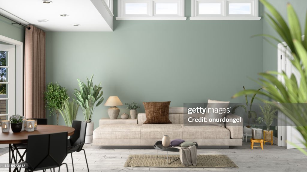 Moderno salón interior con plantas verdes, sofá y fondo de pared verde