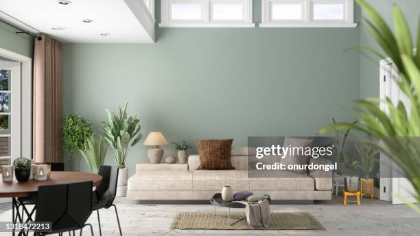 modern vardagsrumsinredning med gröna växter, soffa och grön väggbakgrund - green color bildbanksfoton och bilder