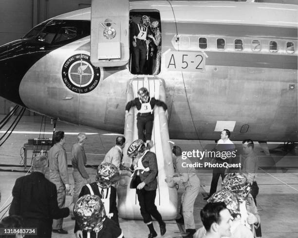 View of flight personnel as they train in aircraft evacuation techniques at the Federal Aviation Administration Aeronautical Center, Oklahoma City,...