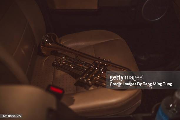 close-up of trumpet on the seat in a car - blues in the night stock-fotos und bilder