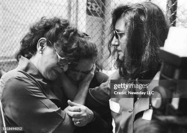 The mothers of two victims of serial killer Joel Rifkin share an emotional moment outside Nassau County Court in Mineola, New York on July 7, 1993....