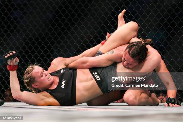 Andrea Lee applies pressure to the arm of Antonina Shevchenko during their Women's Flyweight Bout of UFC 262 at Toyota Center on May 15, 2021 in...