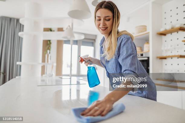 woman at home - spray cleaner stock pictures, royalty-free photos & images