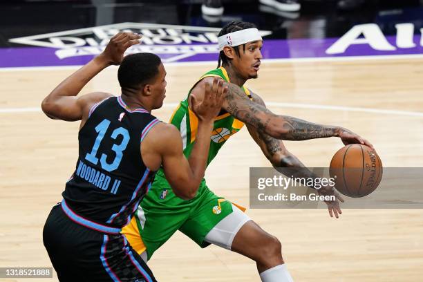 Jordan Clarkson of the Utah Jazz throws a no-look pass around Robert Woodard II of the Sacramento Kings at Golden 1 Center on May 16, 2021 in...