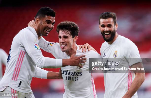 Nacho Fernandez of Real Madrid celebrates with his teammate Carlos Casemiro and Alvaro Odriozola of Real Madrid after scoring the opening goal during...