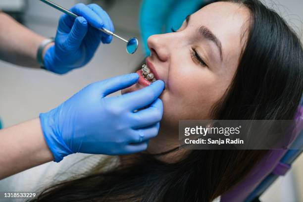 denture adjustment - blue glove stock pictures, royalty-free photos & images