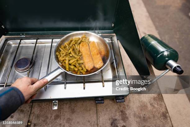 cooking vegan sausage and green beans for breakfast on a camping stove - camping stove stock pictures, royalty-free photos & images