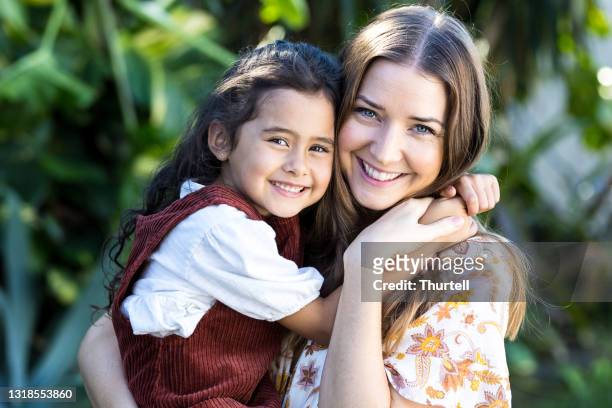 mother and young daughter embracing - australasia stock pictures, royalty-free photos & images