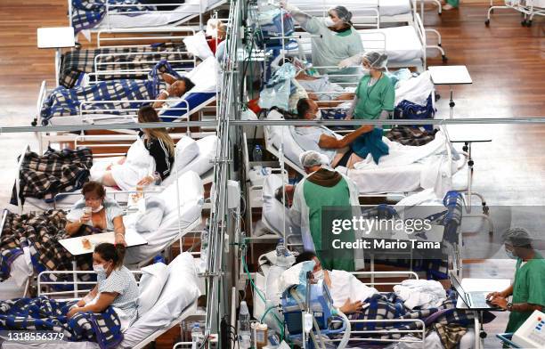 Health care workers care for COVID-19 patients at a field hospital set up in the Pedro Dell’Antonia Sports Complex on May 17, 2021 in Santo Andre,...