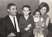 Vintage image made in the 60s: Smiling mature couple posing with their children