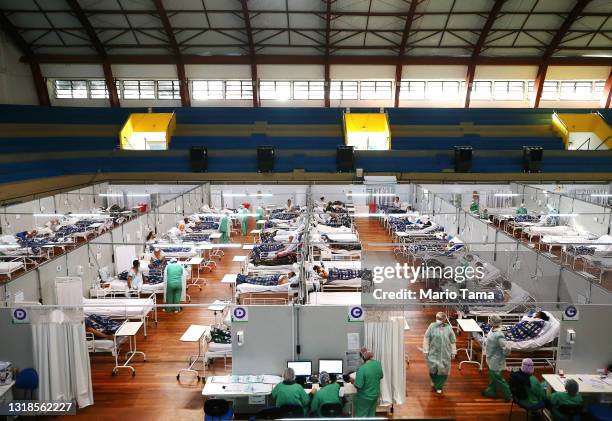 Health care workers care for COVID-19 patients at a field hospital set up in the Pedro Dell’Antonia Sports Complex on May 17, 2021 in Santo Andre,...