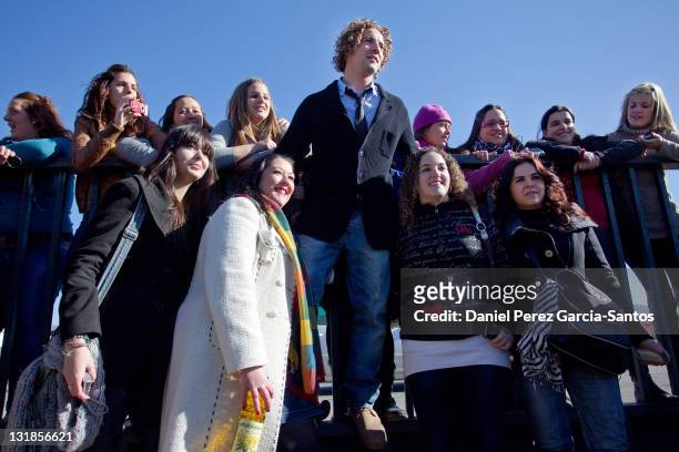 Spanish singer David Bisbal poses with some fans after a photocall in which he was presented as the new face of the Hojiblanca Group at the group...