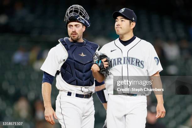 Tom Murphy and Yusei Kikuchi of the Seattle Mariners meet at the pitchers mound during the first inning against the Detroit Tigers at T-Mobile Park...