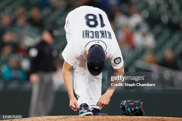 Yusei Kikuchi of the Seattle Mariners ties his shoe during the sixth inning against the Detroit Tigers at T-Mobile Park on May 17, 2021 in Seattle,...
