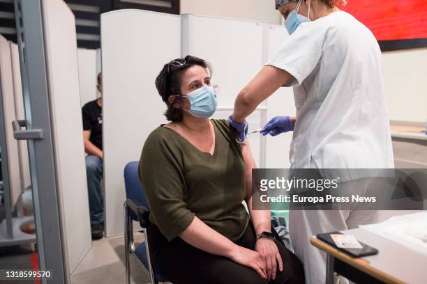 Healthcare worker administers the first dose of Pfizer's vaccine to a woman at the University Hospital of Getafe on May 17, in Getafe, Madrid, Spain....