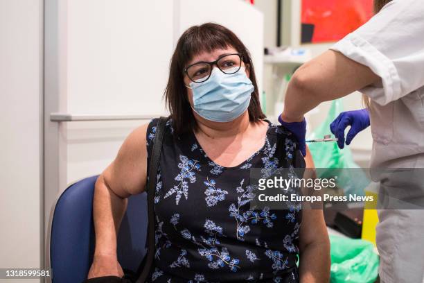Healthcare worker administers the first dose of Pfizer's vaccine to a woman at the University Hospital of Getafe on May 17, in Getafe, Madrid, Spain....