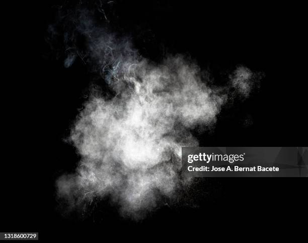 explosion of a cloud of particles of smoke of white color on a black background. - smoke black background ストックフォトと画像