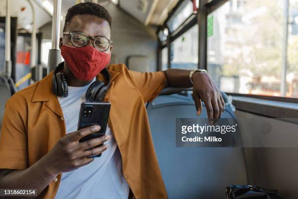 confident young african-america in public transport - protective face mask happy stock pictures, royalty-free photos & images