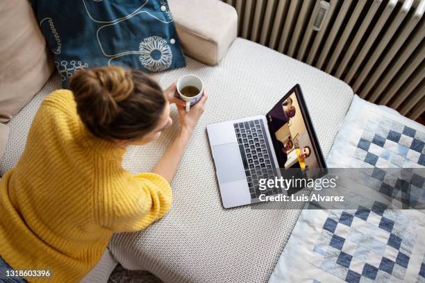 woman at home talking with friends on video call - coffee meeting with friends foto e immagini stock