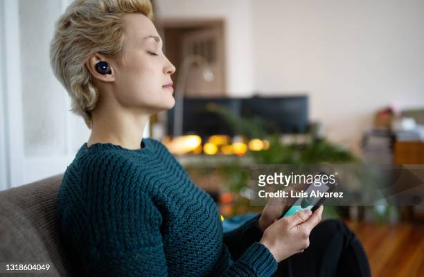 woman practicing breathing using mindful breathing app - stay at home order stock pictures, royalty-free photos & images